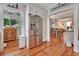Efficient kitchen featuring stainless steel appliances, hardwood floors, and access to a sunlit porch, blending functionality with style at 1056 Stevens St, Lake Helen, FL 32744