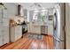 Modern kitchen showcasing stainless steel appliances, ample counter space, and hardwood floors, perfect for cooking and entertaining at 1056 Stevens St, Lake Helen, FL 32744