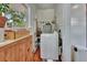 Efficient laundry area with a washing machine and storage cabinets, designed for convenience and organization at 1056 Stevens St, Lake Helen, FL 32744