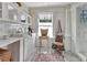 Bright laundry room with white cabinets, a sink, and a marble backsplash at 1056 Stevens St, Lake Helen, FL 32744
