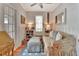 Cozy room boasts wood paneled walls, a ceiling fan, and a comfortable floral sofa and is filled with natural light at 1056 Stevens St, Lake Helen, FL 32744