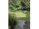 Backyard view featuring a grassy lawn, trees, and plants at 110 Amigos Rd, Debary, FL 32713