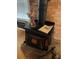Close up of wood burning stove against a red brick accent wall at 110 Amigos Rd, Debary, FL 32713