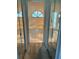 Hallway shot of a bathroom with half-moon window, bath and shower combination at 1118 Prescott Blvd, Deltona, FL 32738