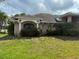 The exterior of the home has a brick facade with mature landscaping at 1118 Prescott Blvd, Deltona, FL 32738