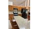 Shows a kitchen with stone countertops and stainless steel appliances at 1118 Prescott Blvd, Deltona, FL 32738