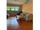 A cozy living room with a sofa, two chairs, and a wooden coffee table at 1118 Prescott Blvd, Deltona, FL 32738