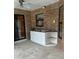 Outdoor kitchen area with white base cabinets and a stainless steel sink set in brick wall at 1118 Prescott Blvd, Deltona, FL 32738