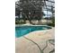 Outdoor pool and hot tub under screened enclosure. View of backyard pond at 1118 Prescott Blvd, Deltona, FL 32738