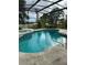 Screened-in pool with spa and lakeside view, perfect for relaxation and enjoying the outdoors at 1118 Prescott Blvd, Deltona, FL 32738