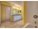 Bright bathroom vanity area featuring granite counters, cabinets, a mirror and a tub-shower combo at 1131 Lemonwood Ave, Deland, FL 32724