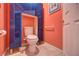 The bathroom features a toilet encased in modern dark blue cabinetry at 1131 Lemonwood Ave, Deland, FL 32724