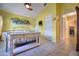 Bright bedroom features a ceiling fan, yellow walls, and a tiled floor at 1131 Lemonwood Ave, Deland, FL 32724