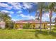 Charming home featuring solar panels, mature landscaping, and a welcoming front entrance at 1131 Lemonwood Ave, Deland, FL 32724