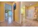 Hallway view of the main bedroom and bathroom with tiled floors and yellow walls at 1131 Lemonwood Ave, Deland, FL 32724