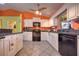 The eat-in kitchen features granite countertops, white cabinets, tile floors, and modern black appliances at 1131 Lemonwood Ave, Deland, FL 32724