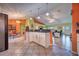 Open-concept home features a kitchen island with granite countertops, an eat-in kitchen, and an adjacent living area at 1131 Lemonwood Ave, Deland, FL 32724