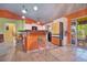 A vibrant kitchen featuring an island, bar stools, colorful walls and white cabinets plus direct access to outdoor patio at 1131 Lemonwood Ave, Deland, FL 32724