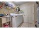 Laundry room with a utility sink, shelving, and a modern washer and dryer at 1131 Lemonwood Ave, Deland, FL 32724