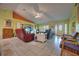 Bright living room featuring tile floors, ample seating, and a large TV at 1131 Lemonwood Ave, Deland, FL 32724