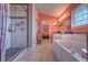 The main bathroom includes a soaking tub, walk-in shower, double vanities, and tile floors at 1131 Lemonwood Ave, Deland, FL 32724