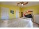 Bright main bedroom boasts a ceiling fan, television, and easy access to other areas of the home at 1131 Lemonwood Ave, Deland, FL 32724