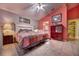 Cozy main bedroom featuring a colorful quilt, ceiling fan, and adjacent bathroom entrance at 1131 Lemonwood Ave, Deland, FL 32724