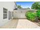 Spacious stone-tiled patio featuring a white door and double windows, along with lush green landscaping and an AC unit at 1155 Taylor E Rd, Deland, FL 32724