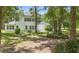 Sprawling backyard with lush green lawn, mature trees, and a picnic table, offering a serene outdoor space at 1155 Taylor E Rd, Deland, FL 32724