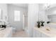 Bright bathroom features dual sinks, marble countertops, and a shower-tub combo at 1155 Taylor E Rd, Deland, FL 32724