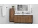Bathroom with double sink vanity, wood cabinet, and illuminated mirror at 1155 Taylor E Rd, Deland, FL 32724