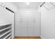 Walk-in closet features white cabinets with drawers, shelving, and closet rod for optimal storage at 1155 Taylor E Rd, Deland, FL 32724