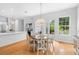 Dining area adjacent to open kitchen features wood floors, chandelier and natural light at 1155 Taylor E Rd, Deland, FL 32724