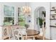 Bright dining room with decorative chandelier, wood floors and views of the landscaped yard at 1155 Taylor E Rd, Deland, FL 32724