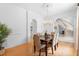 Formal dining room features a wooden table, chandelier, and staircase in an open-concept design at 1155 Taylor E Rd, Deland, FL 32724
