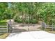 Gated driveway leads to a large, luxurious home partially obscured by mature trees at 1155 Taylor E Rd, Deland, FL 32724