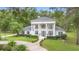 Elegant two-story home boasting grand columns, dark shutters, and meticulously manicured landscaping at 1155 Taylor E Rd, Deland, FL 32724