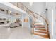 Grand foyer featuring a sweeping staircase, tile floors, and view into the living room at 1155 Taylor E Rd, Deland, FL 32724