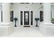 Inviting front porch featuring an elegant front door flanked by decorative plants and columns at 1155 Taylor E Rd, Deland, FL 32724