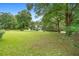 Expansive front yard with a lush green lawn, mature trees, and a long driveway leading to a beautiful home at 1155 Taylor E Rd, Deland, FL 32724
