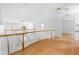 Upstairs hall features bright interior and view of downstairs living area with white railings at 1155 Taylor E Rd, Deland, FL 32724