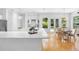 Bright, all-white kitchen boasts a large island, modern appliances, and a sun-filled breakfast nook at 1155 Taylor E Rd, Deland, FL 32724