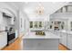 The open-concept kitchen offers a large island, stainless steel appliances, and a breakfast nook with backyard views at 1155 Taylor E Rd, Deland, FL 32724