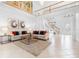 Spacious living room boasts natural light, a soaring ceiling, and a view of the staircase at 1155 Taylor E Rd, Deland, FL 32724