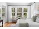 Bright main bedroom featuring wood floors, and large windows overlooking a wooded lot at 1155 Taylor E Rd, Deland, FL 32724
