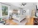 Bright main bedroom featuring a ceiling fan, wood floors, and natural light from large windows at 1155 Taylor E Rd, Deland, FL 32724