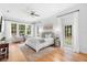 Spacious main bedroom featuring a ceiling fan and natural light from large windows at 1155 Taylor E Rd, Deland, FL 32724