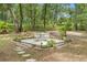 Charming backyard patio area with a table, chairs, and stepping stones, perfect for outdoor relaxation and entertaining at 1155 Taylor E Rd, Deland, FL 32724