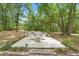 Inviting backyard patio area with a table, chairs, and garden lights, creating a perfect spot for relaxation and gatherings at 1155 Taylor E Rd, Deland, FL 32724