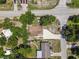 Birds eye view of the home displaying the proximity to the road and surrounding trees at 1214 Flomich St, Daytona Beach, FL 32117